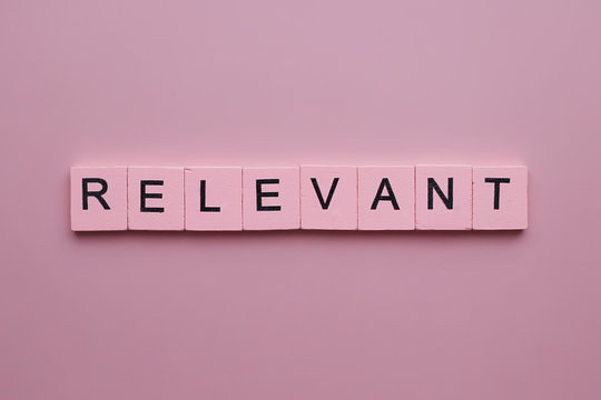 Relevant word wooden cubes on pink background