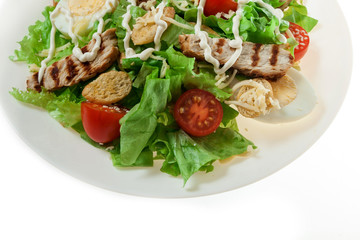 Caesar salad with grill chicken fillet isolated on white background