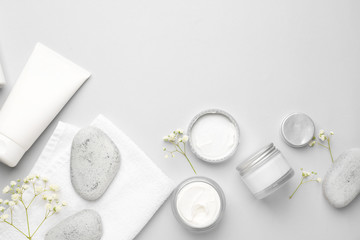 Cosmetic cream with spa items on white background