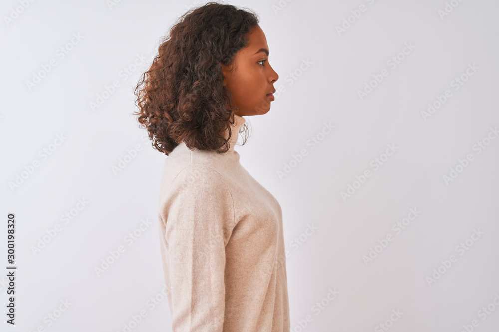 Poster Young brazilian woman wearing turtleneck sweater standing over isolated white background looking to side, relax profile pose with natural face with confident smile.