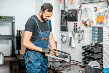 Fototapeta premium Handyman working with metal at the workshop