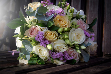 Floral wedding decoration. Wedding table setting decorated with fresh flowers. Wedding floristry. Bouquet with roses, eustoma and eucalyptus leaves.