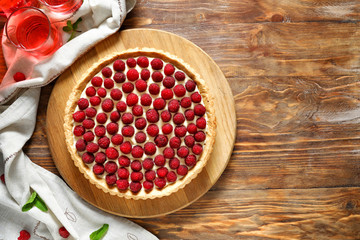 Tasty raspberry pie on wooden table