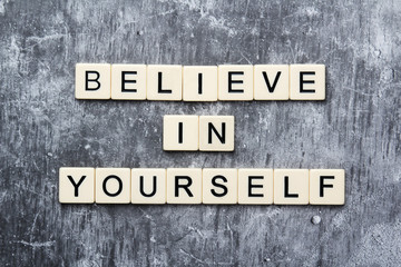 Fototapeta premium Letters forming a motivation phrase Believe in yourself