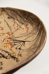 handmade clay plate with prints of plants