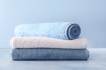 Soft clean towels on color background