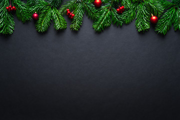 Black Christmas border with fir branches and baubles