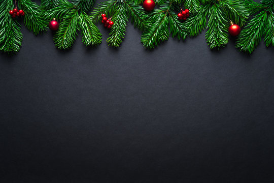 Black Christmas border with fir branches and baubles