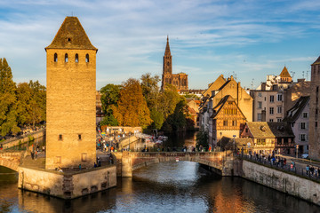 Strasbourg cityscape of the historic medieval district La Petite France with the cathedral in the background.. Scenic and iconic city view at dusk. France. - obrazy, fototapety, plakaty