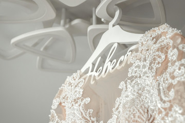 composition - a wedding dress on a gray blue wall with decor and accessories. The concept of marriage, family relationships, wedding paraphernalia.