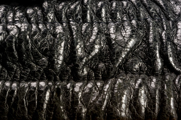 Old vintage genuine soft black leather texture background, top layer with pores and scratches,...