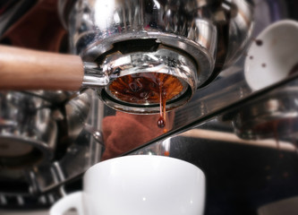 Making espresso coffee in coffeeshop or cafe closeup