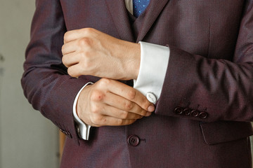 Hands of a businessman, closeup, button sleeves on a shirt.
