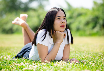 Girl is walking through the park in lighty dress