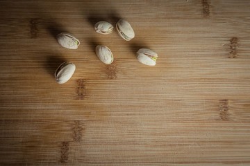 Pistachios nuts on the wood board top view