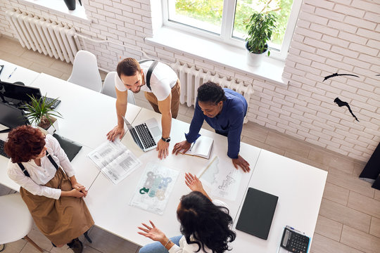 Business team consisted of multiethnic people, gathered in office to discuss new project - Powered by Adobe