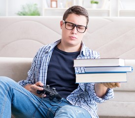 Young student trying to balance studying and playing games