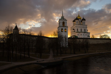 Beautiful panorama of the medieval fortress with the bell tower and the Cathedral on the background of sunset. Pskov, Russia.