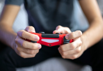 young man playing video game with gamepad front view
