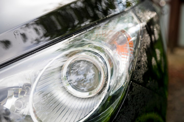 Closeup headlights of car.Modern and luxury car headlights. Exterior detail. car in self serve...
