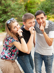 happy group of friends smiling outdoors in a park