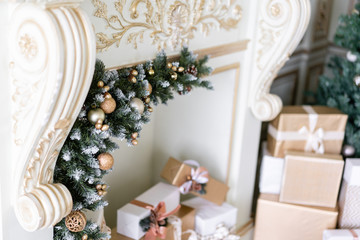 Christmas morning. Classic luxurious apartments with decorated christmas tree and presents. Living with fireplace, columns and stucco.