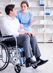 Disabled patient on wheelchair visiting doctor for regular check