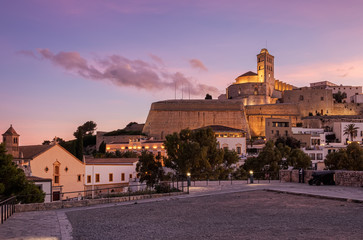 Beautiful sunset from the viewpoint of the historic area of ​​Dalt Vila in Ibiza, Baleares, Spain. Cathedral and white houses in the wall area - obrazy, fototapety, plakaty