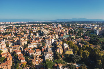 Naklejka premium Aerial view of Rome Italy residential areas with houses, flight on drone above city buildings in sunny day.