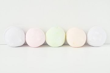 Air marshmallows in pastel shades. A gentle marshmallows.  Marshmallows that you want to eat. A gentle zephyr on a white background. Marshmallows in a light key.