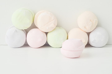 Air marshmallows in pastel shades. A gentle marshmallows.  Marshmallows that you want to eat. A gentle zephyr on a white background. Marshmallows in a light key.