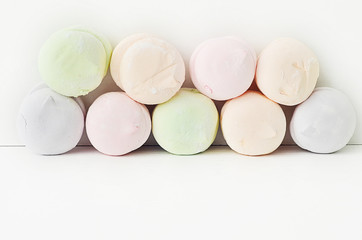Air marshmallows in pastel shades. A gentle marshmallows.  Marshmallows that you want to eat. A gentle zephyr on a white background. Marshmallows in a light key.