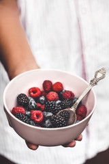 Holding a plate full of berries. Breakfast mix. Raspberries, blueberries, blackberries. plate
