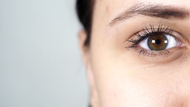 Macro image of human eye with contact lens. Woman's eye close-up. Human eye with long eyelashes with mascara. Cosmetics and makeup.