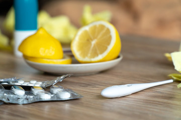 sliced lemon with cold pills on table