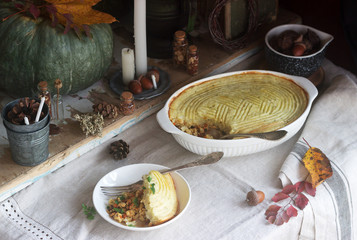 Rustic pie stuffed with minced chicken and cauliflower, and autumn still life on a wooden background. Rustic style.