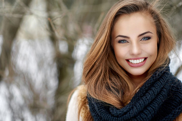 Beautiful smiling woman outdoor winter portrait - close up