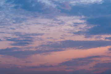 Purple or orange sunset sky with gray and blue clouds. Background image..