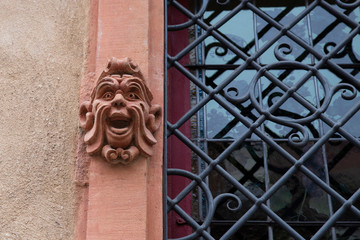 Gargoyle on the facade of a house in Alsace