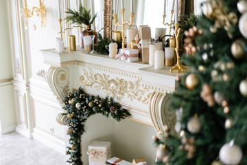 Close-up branches of Christmas tree with ornaments. Christmas balls, ribbon bow, snowflakes, pine cones and lights.
