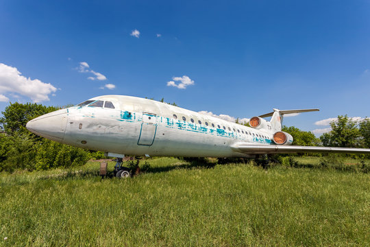 Old russian aircraft Yak-42 at an abandoned aerodrome in summertime