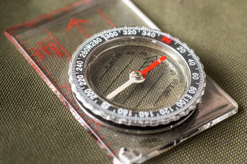 Compass with pointing red arrow to the north. Close-up.