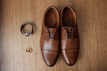 Wedding accessories, shoes, watches, rings, bow tie. The concept of marriage, family relationships, wedding paraphernalia.