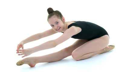 The gymnast perform an acrobatic element on the floor.