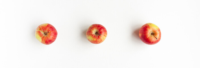 Banner flat lay top view of tree red apples on white background. Food concept