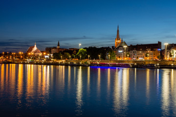 Fototapeta na wymiar Szczecin in Poland. Light reflections of buildings in the river