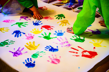 Children hand prints on white wall background,selective focus