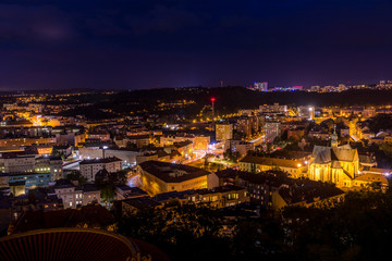 Busy street with people, cars and public transport rush street in Brno Silingrovo namesti square in Czech Republic Europe capture in close shot between buildings.