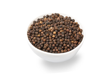 Vibrant black peppercorns in bowl isolated on white background