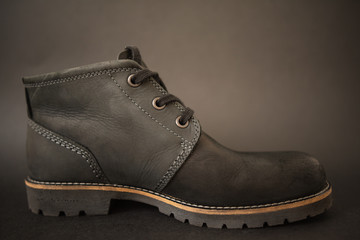 vintage black boots on black background, retro shoes